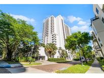 Stunning high-rise condo building with modern architecture and lush landscaping creating an inviting entrance at 530 E Central Blvd # 705, Orlando, FL 32801