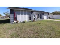 Charming single-Gathering home with a well-manicured lawn and inviting curb appeal at 763 Royal Palm Dr, Kissimmee, FL 34743