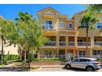 Charming townhome with balconies and lush landscaping, creating a warm and inviting curb appeal at 1447 Lake George Dr, Lake Mary, FL 32746