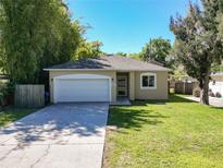 Charming single-story home featuring a well-manicured lawn and an attached two-car garage at 2006 E Harding St, Orlando, FL 32806