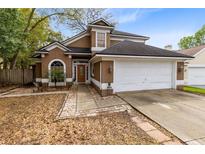 Charming two-story home with a well-maintained lawn and inviting entryway at 217 Oak Park Pl, Casselberry, FL 32707