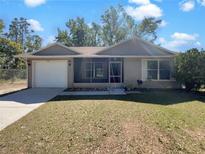 Charming single-story home with a well-maintained lawn and inviting screened-in porch at 233 Chadworth Dr, Kissimmee, FL 34758