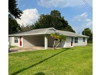 Charming single-story home with a spacious carport and well-manicured front lawn at 143 Louisiana Ave, St Cloud, FL 34769