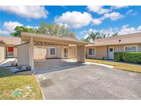 Charming home featuring a carport, landscaped yard, and inviting entrance at 1912 Abbington St # Ge, Apopka, FL 32712