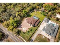 A stunning aerial view of this luxury home with a private pool, lush greenery, and spacious grounds at 1984 Windermere Rd, Windermere, FL 34786