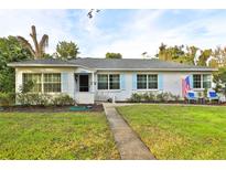 Charming single-story home with a well-manicured lawn and beautiful blue shutters at 2381 Roxbury Rd, Winter Park, FL 32789