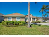 Charming single-story home with well-manicured landscaping and vibrant green lawn at 2721 University Acres Dr, Orlando, FL 32817