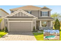 Charming two-story home with a gray facade, well-manicured lawn, and screened in pool at 432 Treasure Ln, Sanford, FL 32771