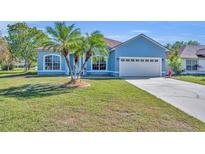 Charming blue single-Gathering home with a well manicured lawn and a two-car garage at 4907 Culdesac Ct, St Cloud, FL 34772