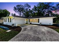 Charming white home with a well-manicured lawn and a spacious driveway at 1338 Franklin St, Altamonte Springs, FL 32701