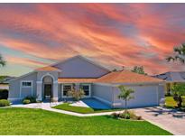 Charming single-story home featuring a well-manicured lawn and inviting entrance at 14901 Wild Wood Lily Ct, Orlando, FL 32824