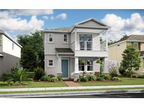 Charming two-story home featuring a balcony, manicured landscaping, and a welcoming front porch, creating an inviting curb appeal at 15573 Gentle Rain Dr # 193, Winter Garden, FL 34787