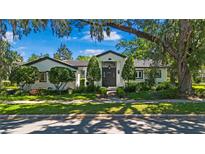 Charming home featuring manicured landscaping, and a striking, modern front door entrance at 1701 Palmer Ave, Winter Park, FL 32789