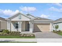 Charming single-story home with a well-manicured lawn, inviting porch, and a two-car garage at 2192 Seagrass Pt # 427, Kissimmee, FL 34747