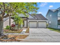 Charming single-story home featuring a two-car garage, well-manicured lawn, and delightful curb appeal at 14209 Lake Live Oak Dr, Orlando, FL 32828