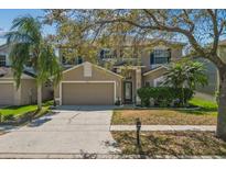 Charming two-story home boasts a well-manicured lawn and a spacious two-car garage, blending comfort and curb appeal at 14931 Hawksmoor Run Cir, Orlando, FL 32828