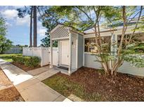 Charming front entrance with lattice work and landscaping, welcoming visitors to this lovely home at 1709 Winter Green Blvd, Winter Park, FL 32792