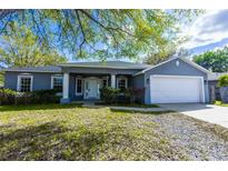 Charming single-story home with a well-manicured lawn and attached two-car garage at 3209 Hanley St, Deltona, FL 32738