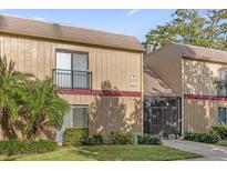 Two-story townhouse with a small balcony, screened-in patio, and well-maintained landscaping at 429 Sheoah Blvd # 3, Winter Springs, FL 32708