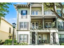 Charming multi-story townhome featuring multiple balconies and classic architectural details at 604 Mulberry Ave # 1201, Kissimmee, FL 34747