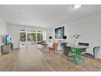 Bright living room featuring sleek floors, a large window with natural light, and modern furnishings at 700 Melrose Ave # L-23, Winter Park, FL 32789