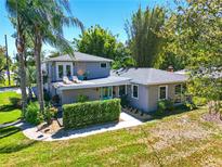 Charming two-story home featuring a teal door, landscaped front yard, and rooftop deck at 1519 N Westmoreland Dr, Orlando, FL 32804