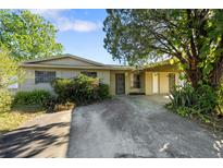 Cozy single-story home with a covered carport and mature landscaping for added curb appeal at 2027 La Due Ct, Orlando, FL 32811