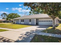 Charming one-story home featuring a well-manicured lawn and a two-car garage, great curb appeal at 284 Mississippi Woods Ln, Orlando, FL 32824