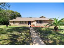 Charming brick home with a well-manicured lawn and inviting walkway at 516 Donaldson Dr, Debary, FL 32713