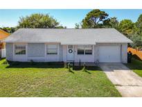 Charming single-story home with a well-maintained lawn, quaint front door, and attached garage at 5322 Winter Run Dr, Orlando, FL 32839