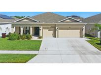 Charming single-story home with a well-manicured lawn and a two-car garage at 588 Hitch Loop, St Cloud, FL 34772