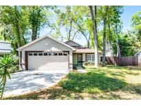 Charming one-story home boasts a two-car garage, mature landscaping, and welcoming curb appeal at 651 Robinhood Dr, Maitland, FL 32751