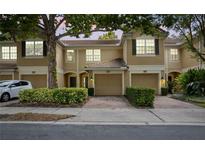 Charming townhome featuring a two-car garage and well-manicured landscaping at 6847 Sperone St, Orlando, FL 32819