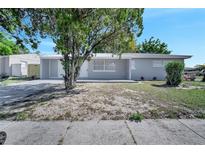 Charming single-story home featuring a well-maintained front yard and a classic exterior design at 73 Garrison Ln, Frostproof, FL 33843