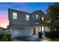 Charming two-story home featuring a two-car garage and a welcoming front porch at 885 Carmillion Ct, Groveland, FL 34736