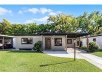 Charming single-story home with a welcoming front porch and a well-maintained lawn at 912 Citrus St, Orlando, FL 32805