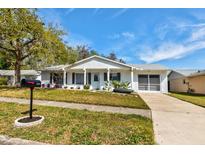 Charming single-story home with a well-maintained lawn and inviting front entrance at 10707 Larissa St, Orlando, FL 32821