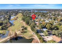 Gorgeous aerial view of home's location on the golf course near a pond and lake at 2259 Minnesota Ave, Winter Park, FL 32789