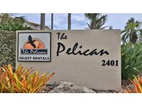 Pelican Select Rentals street-level sign at the entrance of a beachfront community at 2401 S Atlantic Ave # D306, New Smyrna Beach, FL 32169
