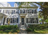 Charming two-story home with a beautiful lawn and dark shutters accenting the windows at 2827 Upper Park Road, Orlando, FL 32814