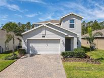 Charming two-story home with a two car garage, paver driveway and a well maintained landscaped yard at 2861 Black Birch Dr, Ocoee, FL 34761