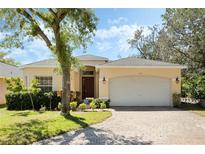 Charming single-story home with a well-manicured lawn, brick driveway and an attached two-car garage at 2933 Star Grass Pt, Oviedo, FL 32766