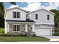 Charming two-story home featuring stone accents and a two-car garage at 33343 Seattle Slew Dr, Sorrento, FL 32776