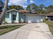Charming single-story home features a two-car garage and well-maintained landscaping at 4798 Windwood Dr, Kissimmee, FL 34746