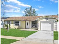 Charming single-story home featuring a well-manicured lawn, attached garage, and inviting front entrance at 5538 Penton Pl, Orlando, FL 32839