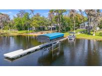 Picturesque waterfront home featuring a private boat dock, lift, and stunning lake views at 5824 N Dean Rd, Orlando, FL 32817