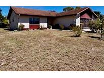 Charming single-story home featuring a well-maintained exterior with a large front yard at 604 Tradewinds Dr, Deltona, FL 32738