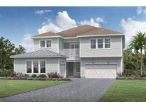 Charming two-story home with a light blue exterior, a front-facing balcony, a driveway, and a two-car garage at 6244 Trailblaze Bnd, St Cloud, FL 34771