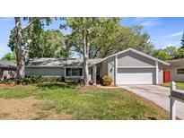 Charming single-story home with well-maintained landscaping and a two-car garage at 104 Cambridge Dr, Longwood, FL 32779