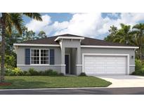 Beautiful single-Gathering home featuring a two-car garage, well-maintained lawn, and classic architectural details at 1355 Wood Line Loop, Deland, FL 32720